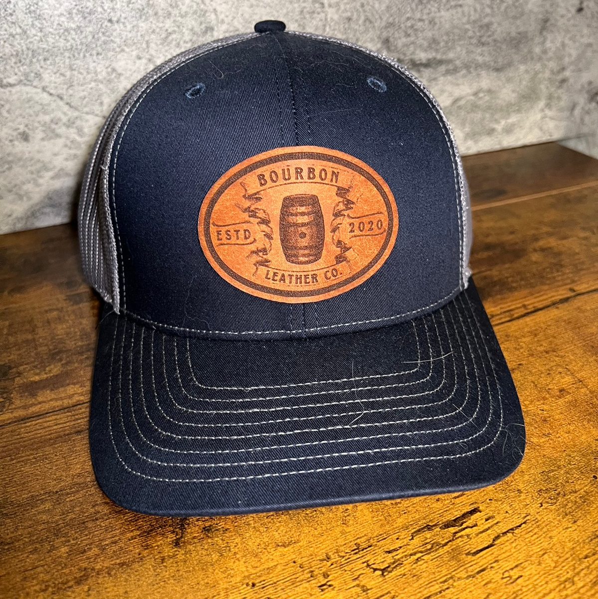 Navy Richardson 112 with an oval leather patch engraved with a bourbon barrel